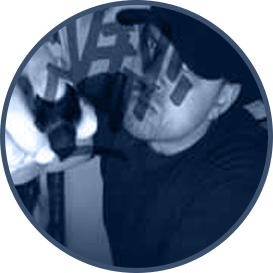 Monochromatic blue-toned portrait of the creative director of Coqui the Chef, Rs Luciano, wearing a black cap and t-shirt.